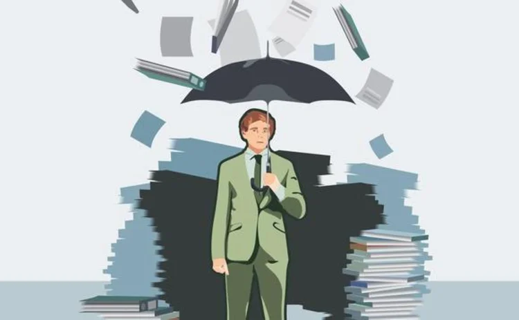 Businessman holding umbrella to protect himself from data rain