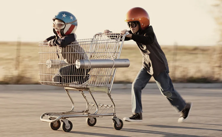 Children racing shopping trolley