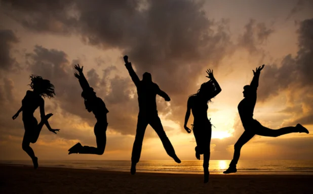 Silhouette of five people on a beach