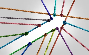 Several coloured strings are joined together creating the shape of a forward-pointing arrow