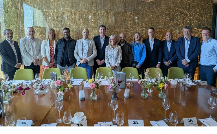 Age/Dual roundtable attendees stand at a table (no names given)