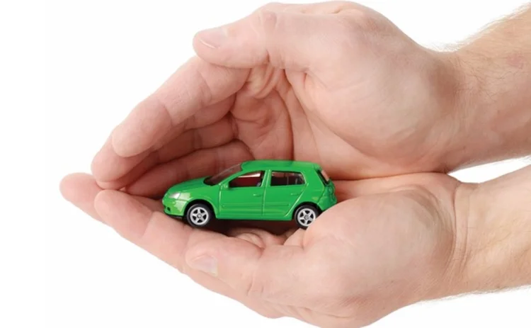car-insurance-toy-car-hands-protect