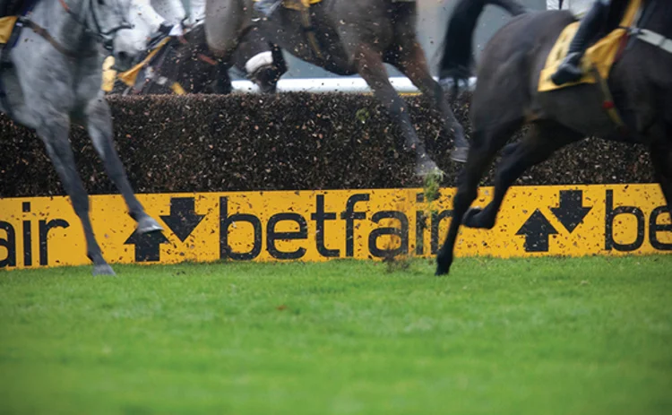 Horse racing in front of Betfair signs
