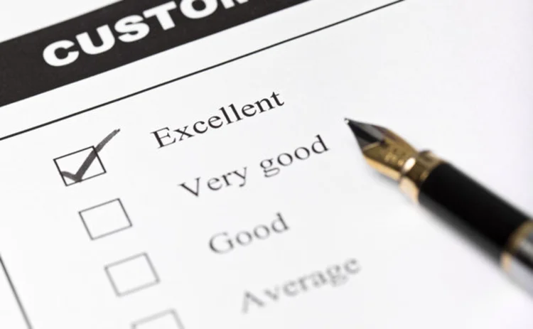 Customer satisfaction survey form with pen closeup with focus on the checked excellent checkbox