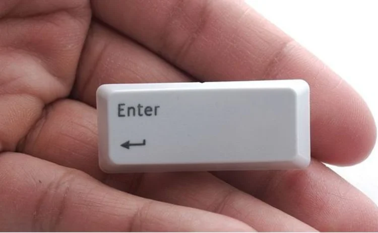 Hand holding enter key