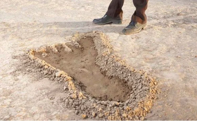 Man viewing giant footprint